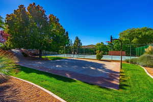 View of basketball court featuring a tennis court and community basketball court