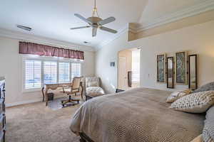 Primary Bedroom featuring lofted ceiling, ornamental molding, arched walkways, carpet flooring, and a ceiling fan