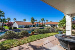 View of patio with a fire pit