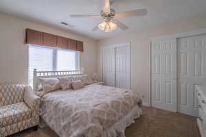 3rd Bedroom featuring two closets, carpet, and ceiling fan