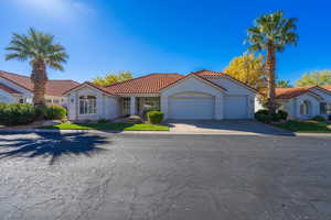 Mediterranean / spanish-style home with a 3 car garage, concrete driveway, stucco siding, and a tiled roof