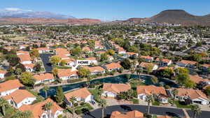 Aerial overview of property's location with a water and mountain view and nearby suburban area