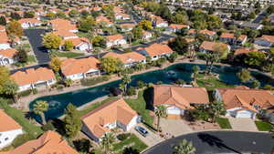 Aerial perspective of suburban area with a nearby body of water