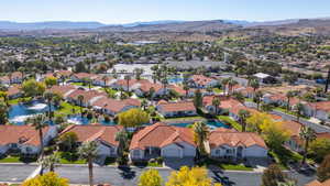 Aerial perspective of suburban area with a mountainous background