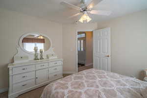 3rd Bedroom with light colored carpet, multiple windows, and a ceiling fan