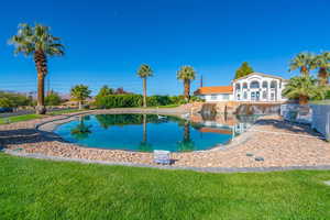 View of pool with a lawn