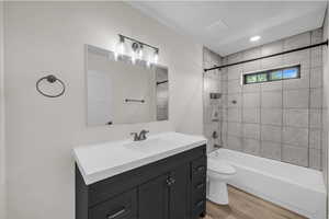 Bathroom featuring shower / washtub combination, vanity, light wood finished floors, and recessed lighting