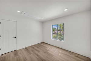 Unfurnished room with recessed lighting and light wood-type flooring