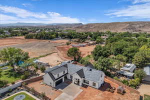 Aerial view of property and surrounding area featuring mountains