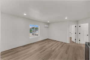 Unfurnished living room featuring recessed lighting and light wood-style flooring