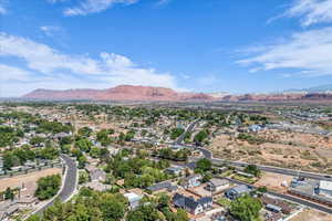 Aerial perspective of suburban area featuring a mountainous background