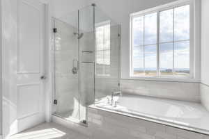 Full bath featuring a stall shower and a bath