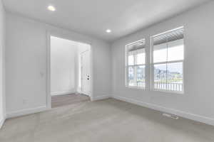Empty room featuring carpet and recessed lighting