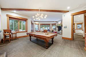Game room featuring pool table, plenty of natural light, recessed lighting, a chandelier, and beamed ceiling