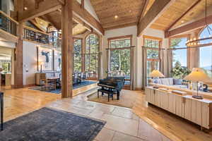 Common area featuring high vaulted ceiling and a wood ceiling with exposed beams