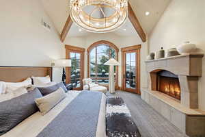 Bedroom with a tile fireplace, access to outside, beamed ceiling, a chandelier, and high vaulted ceiling
