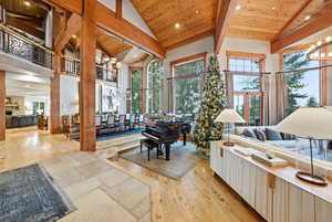 Living area with a chandelier, light wood finished floors, recessed lighting, a wood ceiling with exposed beams, and high vaulted ceiling