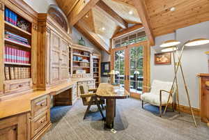 Home office with french doors, built in desk, light colored carpet, a wooden ceiling with exposed beams, and recessed lighting