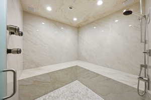Bathroom featuring a marble finish shower and recessed lighting