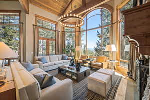 Sunroom / solarium featuring a chandelier and french doors