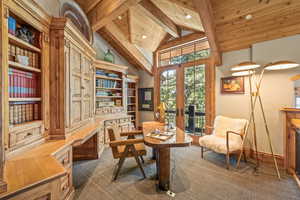 Living area featuring french doors, a wooden ceiling with exposed beams, high vaulted ceiling, dark carpet, and built in study area
