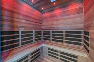 Relaxing sauna / steam room with wooden ceiling, recessed lighting, and wooden walls