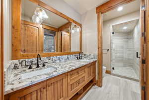 Bathroom featuring double vanity, a stall shower, and recessed lighting