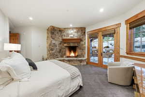 Bedroom featuring access to exterior, a fireplace, french doors, carpet floors, and recessed lighting