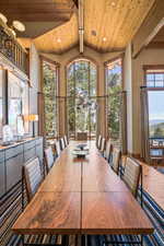 Dining space featuring a chandelier and wood ceiling