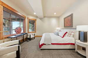 Carpeted bedroom with recessed lighting and baseboards