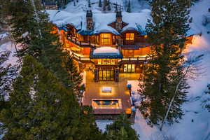 Snow covered house featuring a chimney