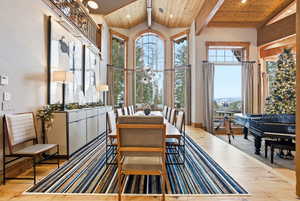 Dining space featuring a chandelier, light wood-type flooring, wood ceiling, and recessed lighting