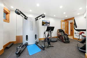 Exercise area with recessed lighting and baseboards