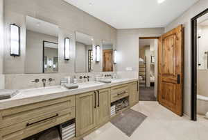 Bathroom featuring double vanity and light tile patterned floors