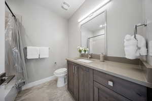 Full bathroom with vanity and curtained shower