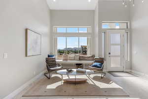 Living room featuring a mountain view and a high ceiling