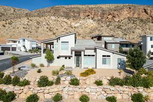 Back of house featuring stucco siding and a mountain view