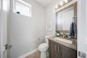 Half bathroom with vanity and toilet