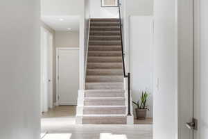 Stairs featuring wood finished floors