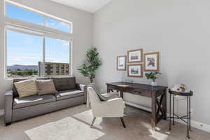 Carpeted office space with a mountain view and baseboards