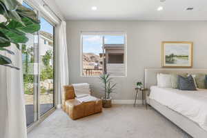 Bedroom featuring access to exterior, carpet floors, and recessed lighting