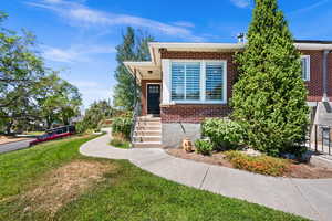 View of front of home featuring brick siding and a front lawn