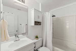 Full bathroom with vanity and shower / bath combination with curtain