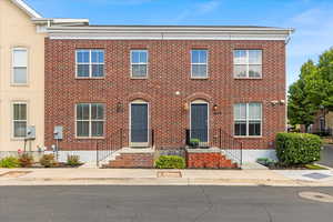 Colonial home with brick siding