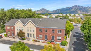 View of front of home featuring brick siding, a mountain view, and a residential view