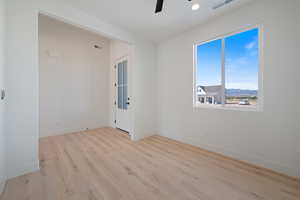 Empty room featuring light wood-type flooring, recessed lighting, and a ceiling fan