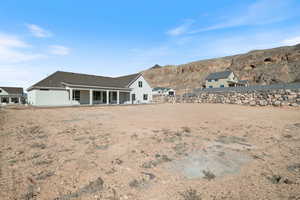 Rear view of house featuring a patio and a mountain view