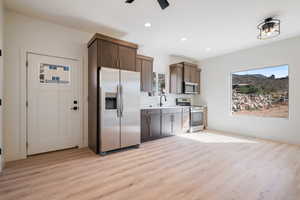 Kitchen with stainless steel appliances, light countertops, light wood finished floors, plenty of natural light, and recessed lighting
