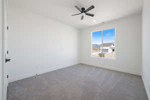 Spare room with carpet flooring and ceiling fan