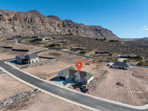 Aerial view of property and surrounding area with mountains